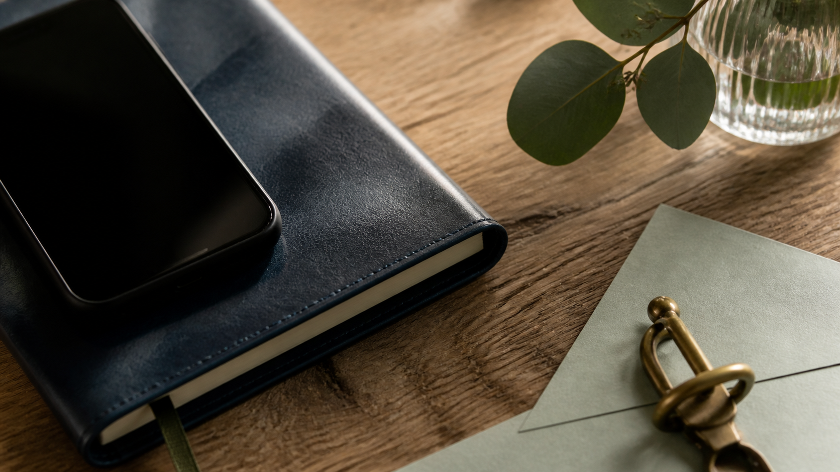 A textured leather sleeve beside a phone with blank screen, with realistic leather and glass.